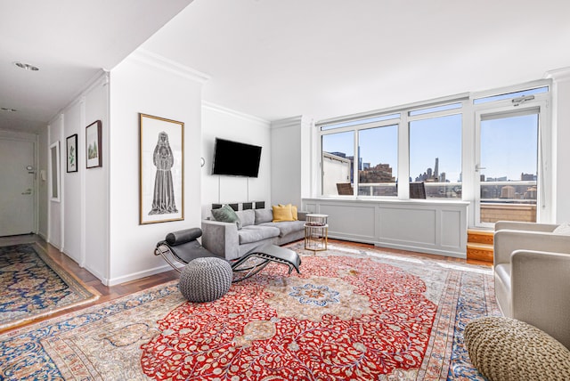 living room featuring baseboards, crown molding, and light wood-style floors