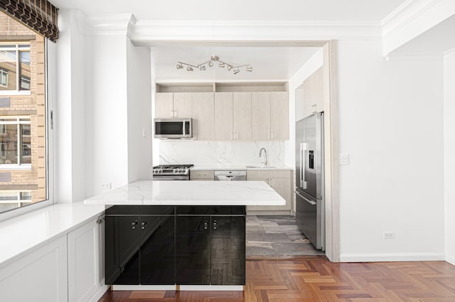 2373 Broadway Unit 1905, New York City, NY 10024 - kitchen featuring appliances with stainless steel finishes, tasteful backsplash, a peninsula, crown molding, and light stone counters