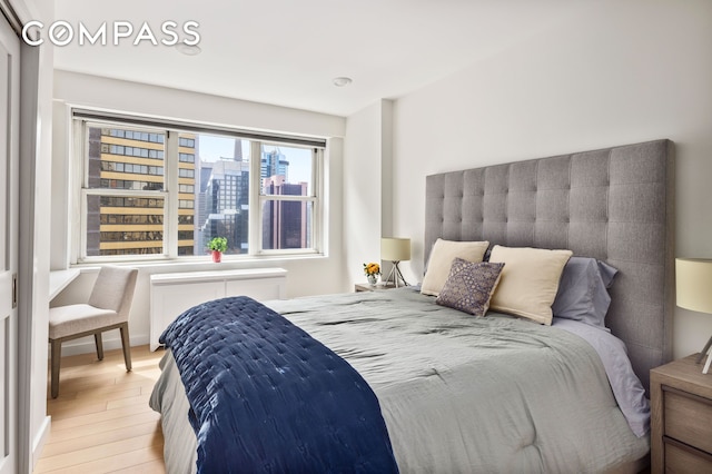 159 W 53rd St Unit 34E, New York City, NY 10019 - bathroom with toilet, vanity, a stall shower, tile walls, and backsplash