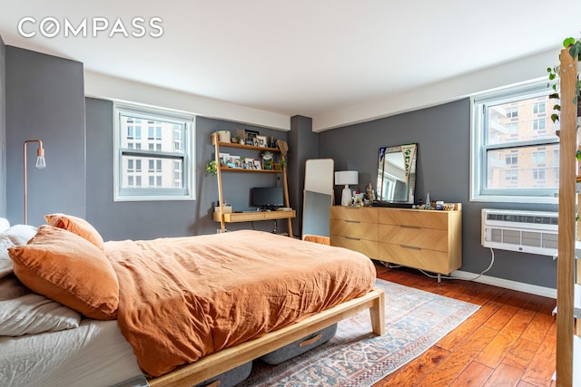 191 Willoughby St Unit 8J, New York City, NY 11201 - bedroom with wood-type flooring, multiple windows, and baseboards