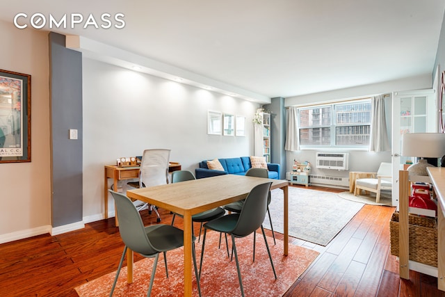 191 Willoughby St Unit 8J, New York City, NY 11201 - dining space featuring wood-type flooring, an AC wall unit, baseboards, and a baseboard heating unit