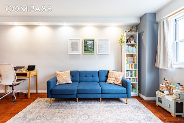 191 Willoughby St Unit 8J, New York City, NY 11201 - living area with wood finished floors, baseboards, and a desk