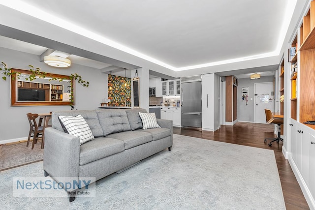 345 E 56th St Unit 3F, New York City, NY 10022 - living room with dark wood-type flooring and baseboards