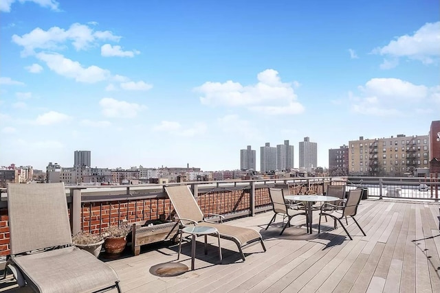 45 Overlook Ter Unit 5A, New York City, NY 10033 - wooden terrace with a view of skyline and outdoor dining space