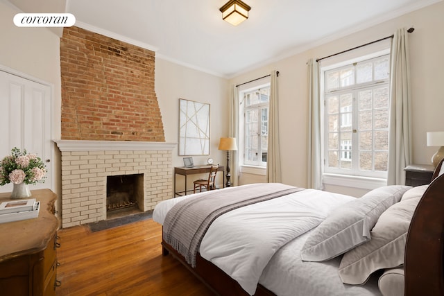 168 Waverly Place Upper, New York City, NY 10014 - bedroom with wood finished floors, ornamental molding, and a brick fireplace