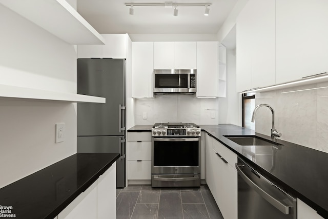 205 E 78th St Unit 17H, New York City, NY 10075 - kitchen with stainless steel appliances, dark countertops, white cabinetry, modern cabinets, and rail lighting