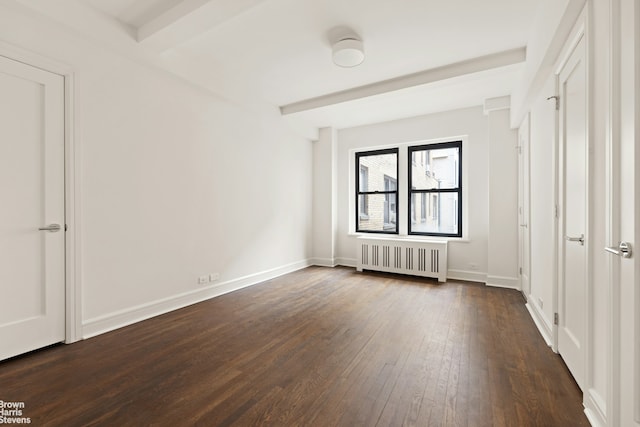 unfurnished bedroom with radiator heating unit, dark wood-style flooring, baseboards, and beamed ceiling