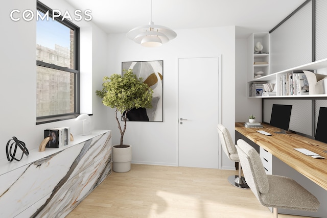 home office with wood finished floors, built in study area, and baseboards