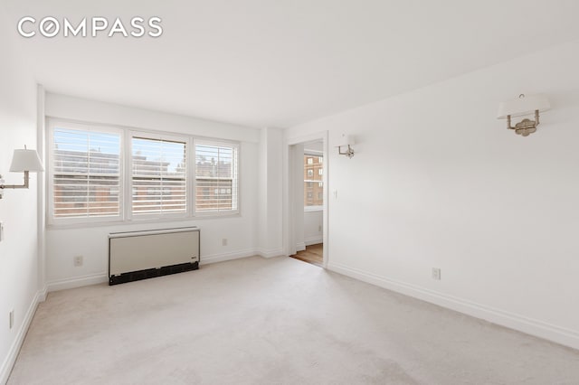 70 E 10th St Unit 14P, New York City, NY 10003 - spare room featuring radiator and carpet