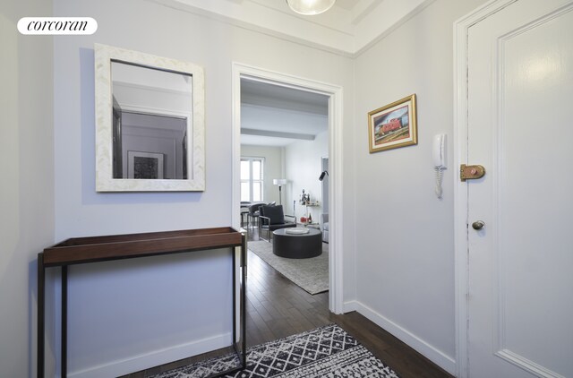 hall featuring baseboards and dark wood finished floors