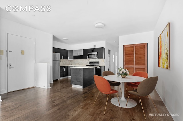 dining space featuring dark wood-style floors and baseboards