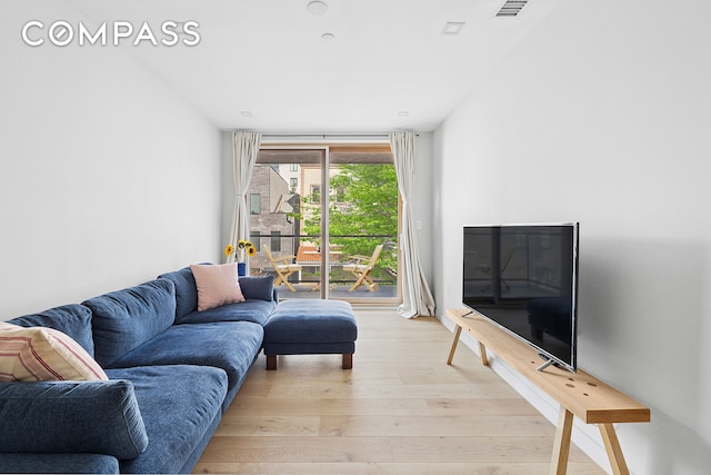 living area with visible vents and light wood-style flooring