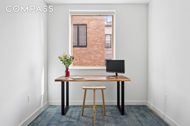 unfurnished office featuring baseboards
