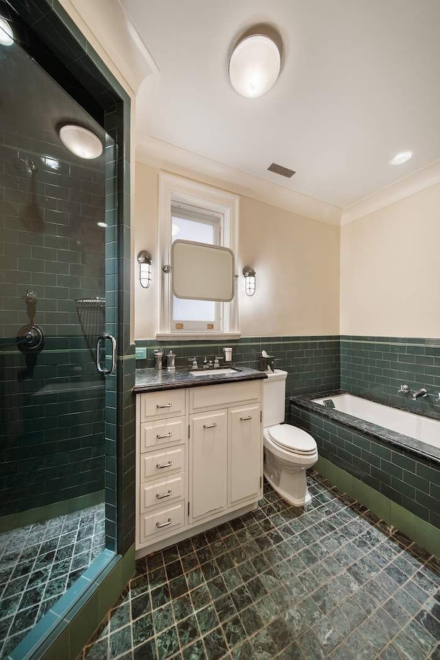 full bath with tiled tub, visible vents, a shower stall, vanity, and toilet