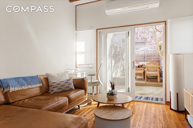 171 Monitor St, New York City, NY 11222 - living area with a wall mounted air conditioner and light wood-style flooring