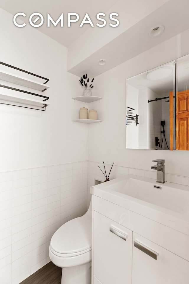 171 Monitor St, New York City, NY 11222 - bathroom with tile walls, vanity, and toilet