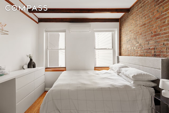 171 Monitor St, New York City, NY 11222 - bedroom with a wall unit AC, beamed ceiling, light wood-type flooring, and brick wall