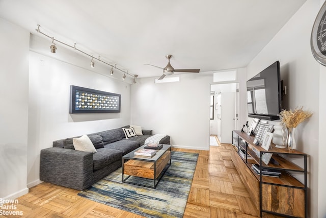 220 E 54th St Unit 8D, New York City, NY 10022 - living area featuring ceiling fan, baseboards, and rail lighting
