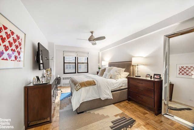 220 E 54th St Unit 8D, New York City, NY 10022 - bedroom with ceiling fan, radiator, and baseboards