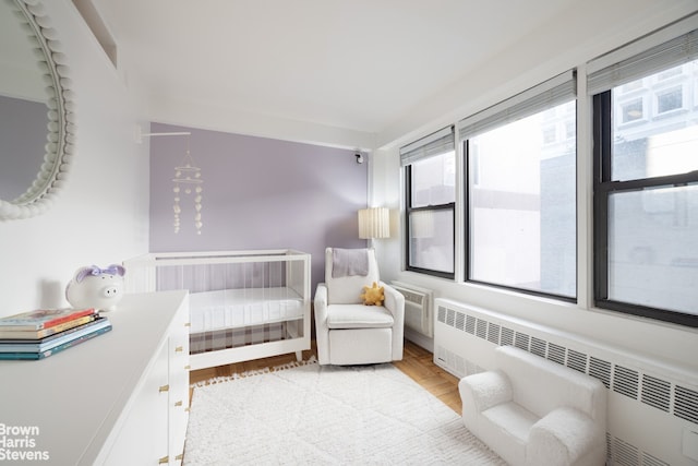 220 E 54th St Unit 8D, New York City, NY 10022 - bedroom with radiator heating unit and light wood finished floors