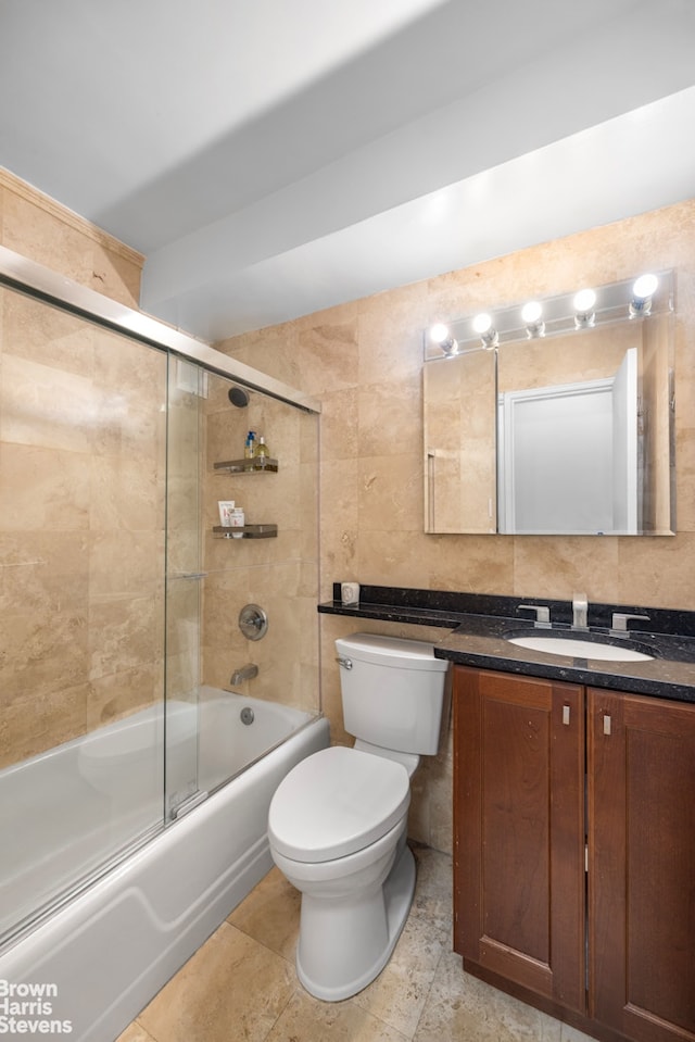 220 E 54th St Unit 8D, New York City, NY 10022 - full bathroom featuring shower / bath combination with glass door, tile walls, toilet, vanity, and backsplash
