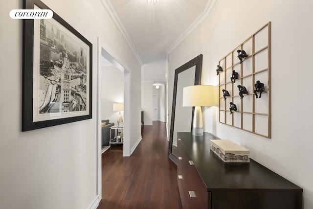 corridor featuring crown molding, dark wood finished floors, and baseboards