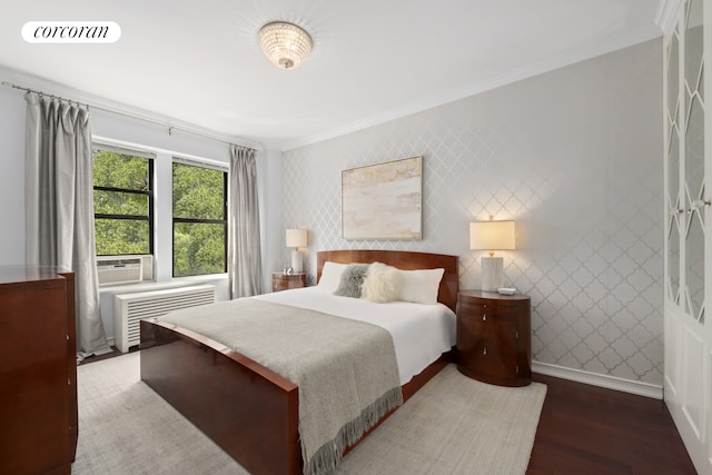 bedroom featuring radiator, ornamental molding, wood finished floors, and cooling unit