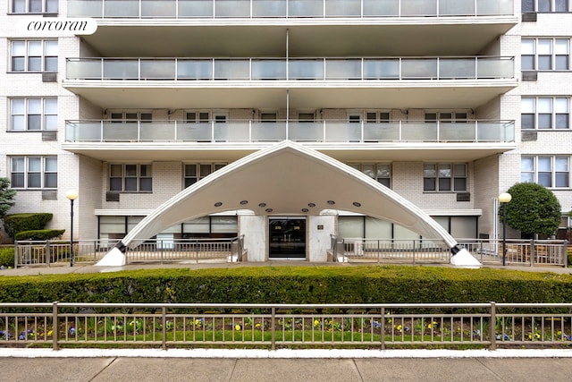 view of apartment building / complex featuring fence