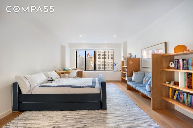 bedroom featuring wood finished floors and recessed lighting