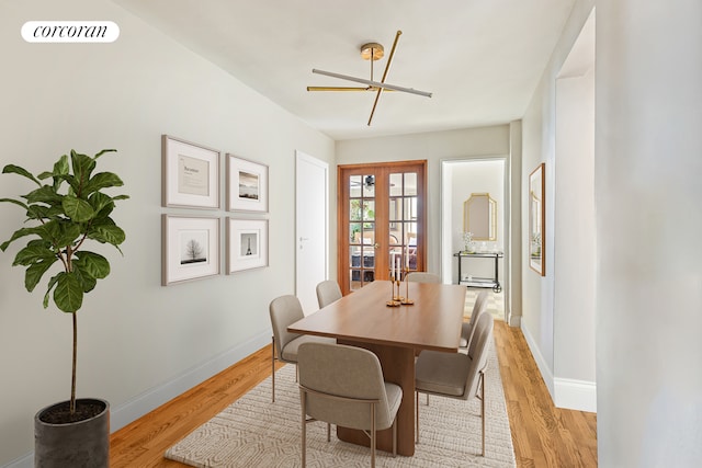 dining room featuring light wood-style floors, baseboards, and french doors