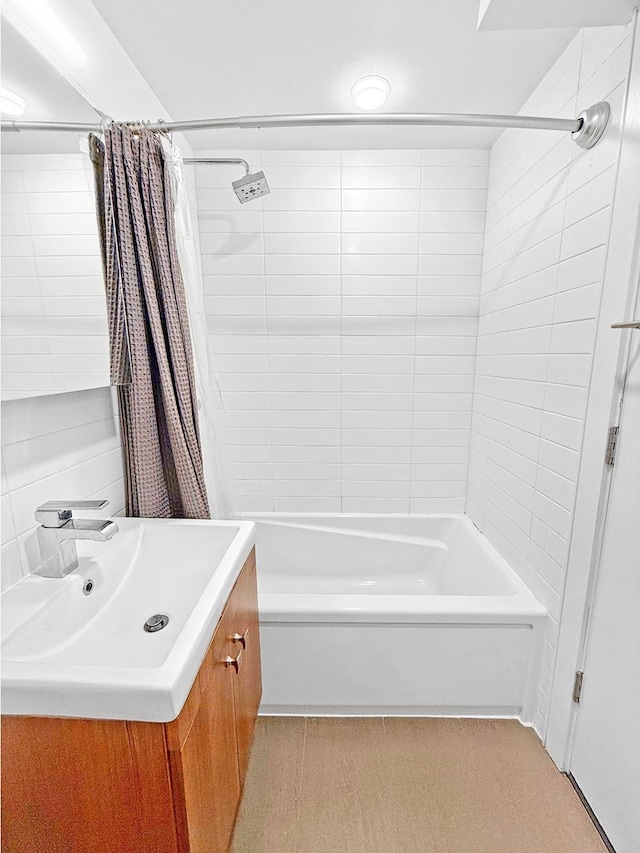 bathroom featuring vanity and shower / bathtub combination with curtain