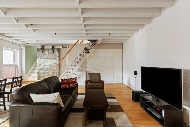 living room with wood finished floors and stairs