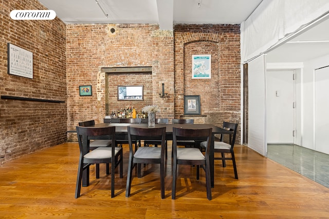 50 Bridge St Unit 501, New York City, NY 11201 - dining room featuring brick wall and wood finished floors