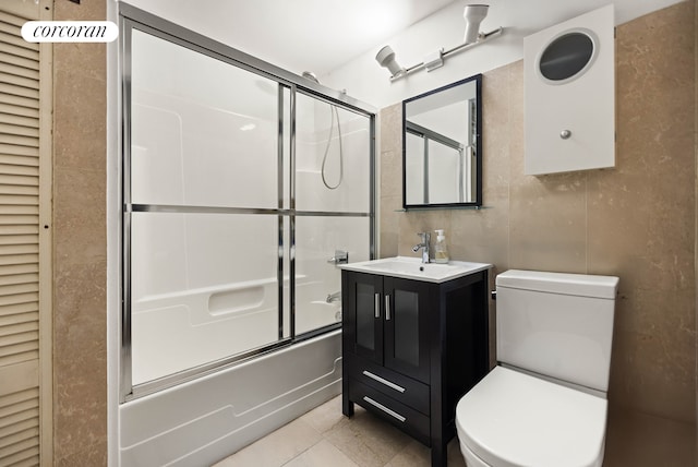 50 Bridge St Unit 501, New York City, NY 11201 - bathroom featuring shower / bath combination with glass door, toilet, vanity, and tile patterned floors