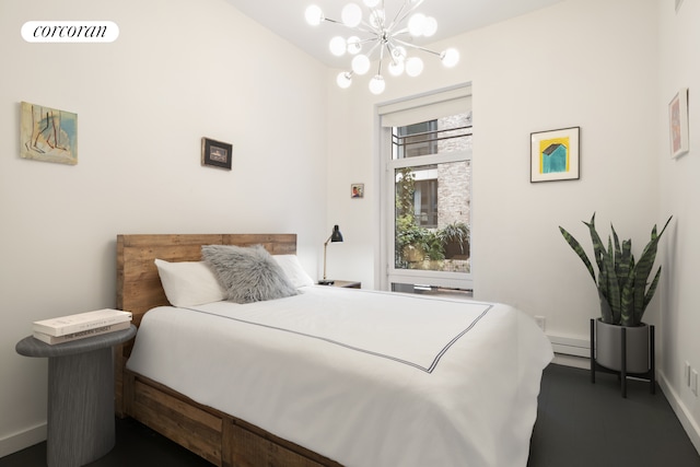 bedroom featuring a chandelier and baseboards