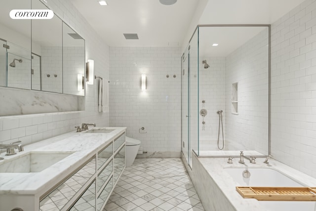 bathroom featuring tile walls, a shower stall, a garden tub, toilet, and tile patterned floors