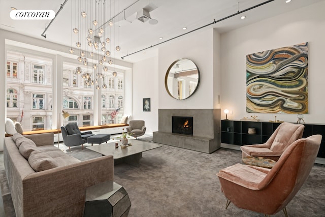 carpeted living room with a lit fireplace