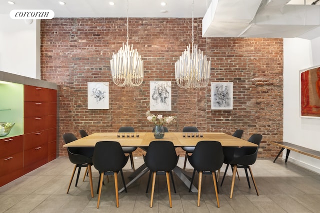 dining area featuring a chandelier, brick wall, light tile patterned flooring, and recessed lighting