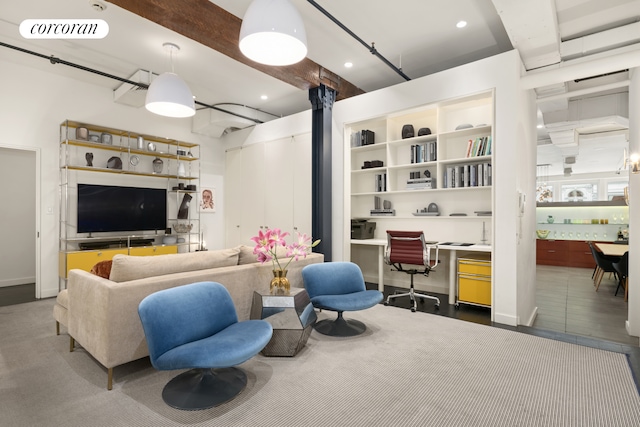 living area with beam ceiling and recessed lighting