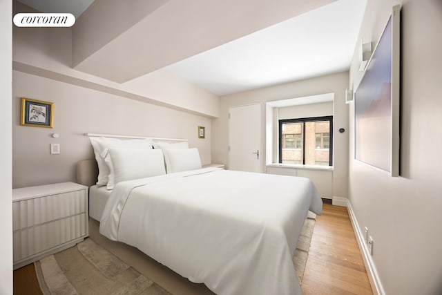421 Hudson St Unit 214, New York City, NY 10014 - bedroom with light wood-type flooring and baseboards