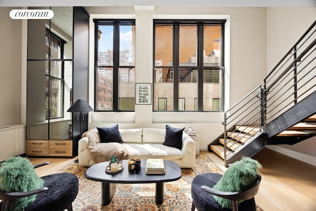 421 Hudson St Unit 214, New York City, NY 10014 - living room with wood finished floors, stairway, plenty of natural light, and baseboards