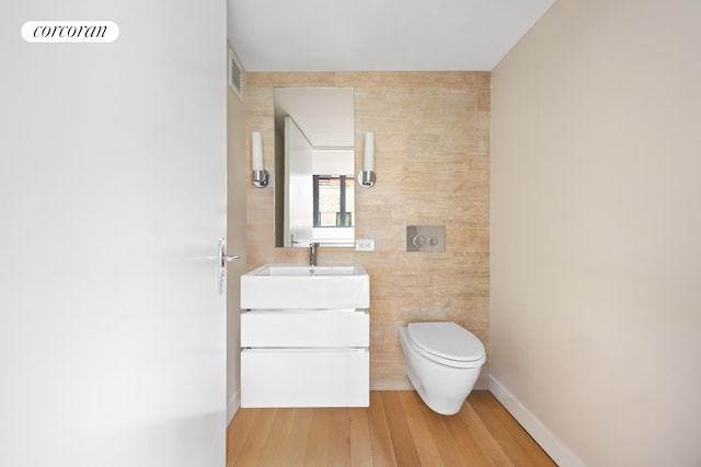 421 Hudson St Unit 214, New York City, NY 10014 - half bath featuring vanity, toilet, and wood finished floors