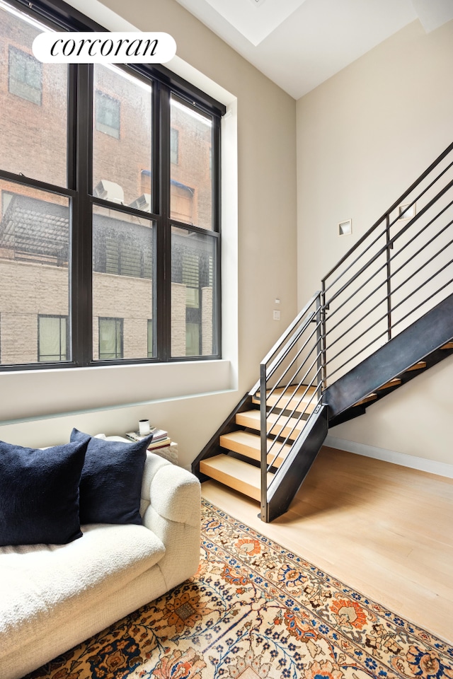 421 Hudson St Unit 214, New York City, NY 10014 - staircase with wood finished floors, baseboards, and healthy amount of natural light