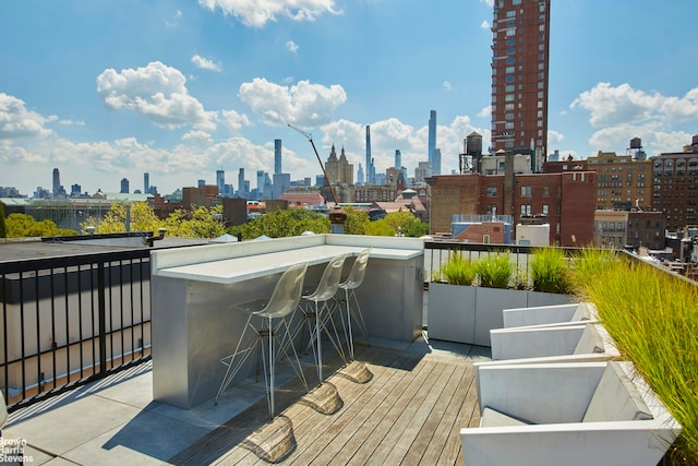 view of patio with a view of skyline and a balcony