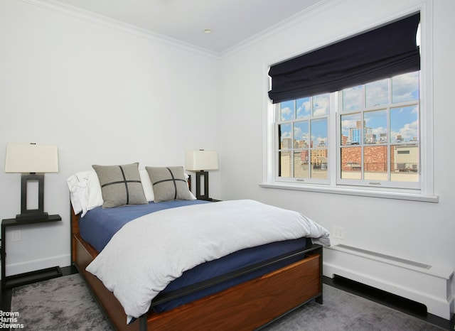 bedroom with baseboards and crown molding