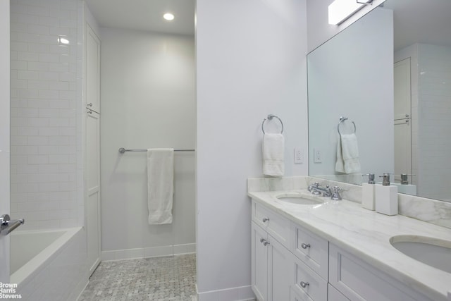 bathroom featuring baseboards, double vanity, recessed lighting, a bathtub, and a shower