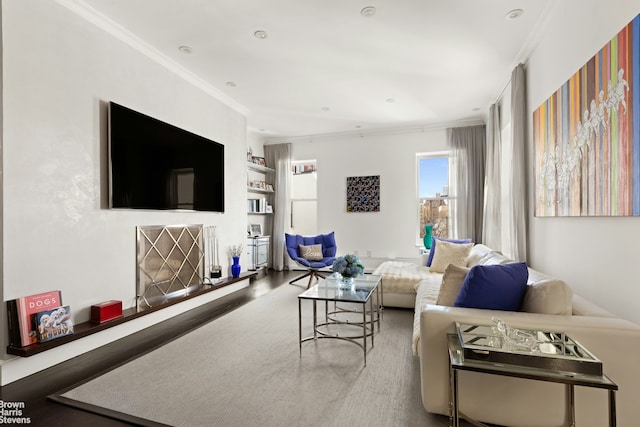 living room featuring crown molding, wood finished floors, and built in shelves