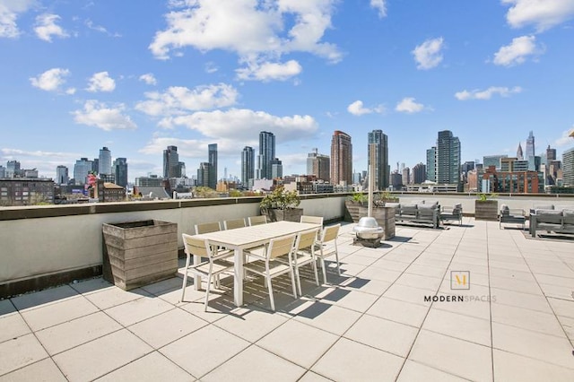 10-55 47th Ave Unit 5-E, New York City, NY 11101 - view of patio featuring a view of skyline and outdoor dining area