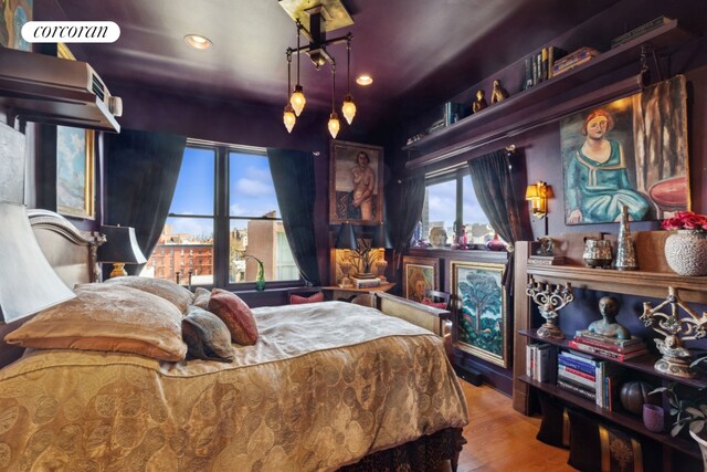 bedroom with recessed lighting and wood finished floors