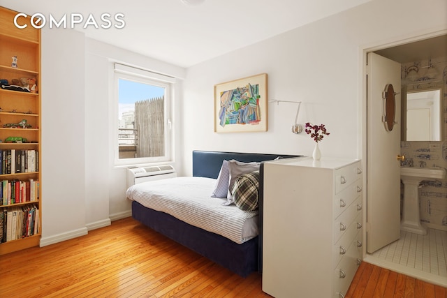 bedroom with light wood-type flooring and baseboards